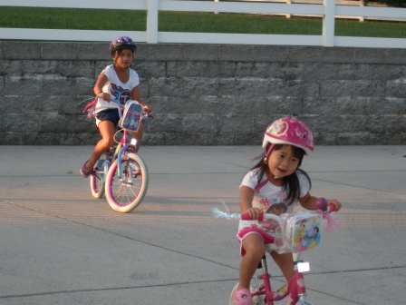 Karis and Kasen riding bikes